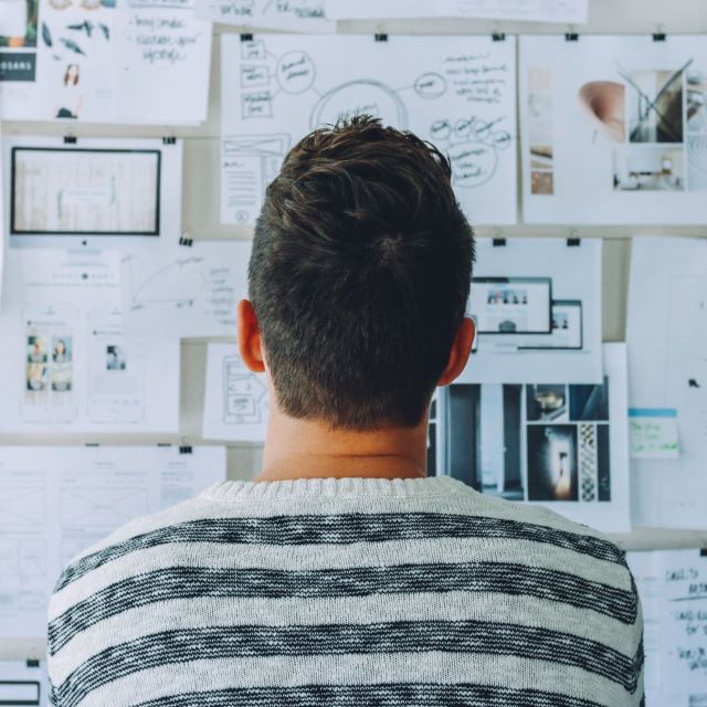 Man staring at vision board
